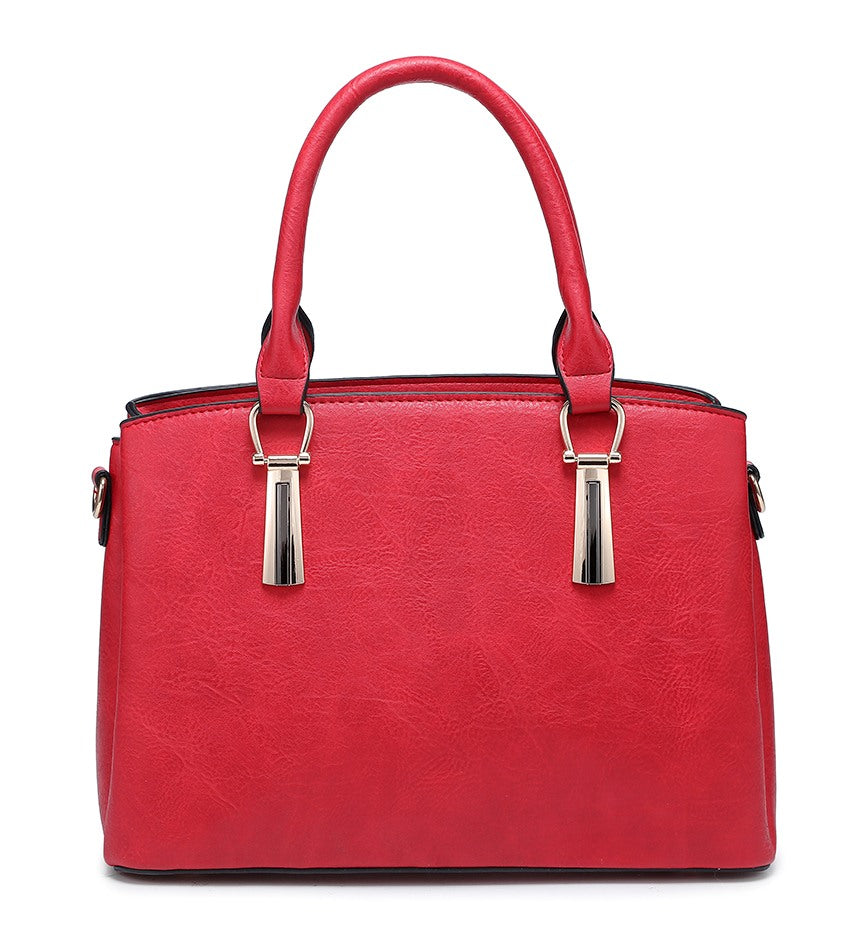 Front view of a red grab bag with twin top handles and decorative metal fittings