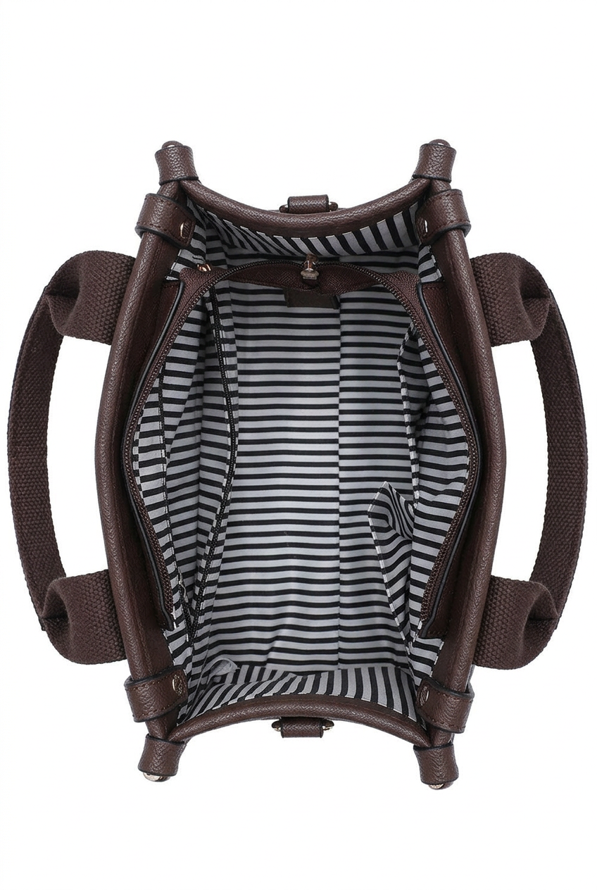 A top-down view of a brown bucket bag showing its striped interior lining with black and white horizontal stripes.