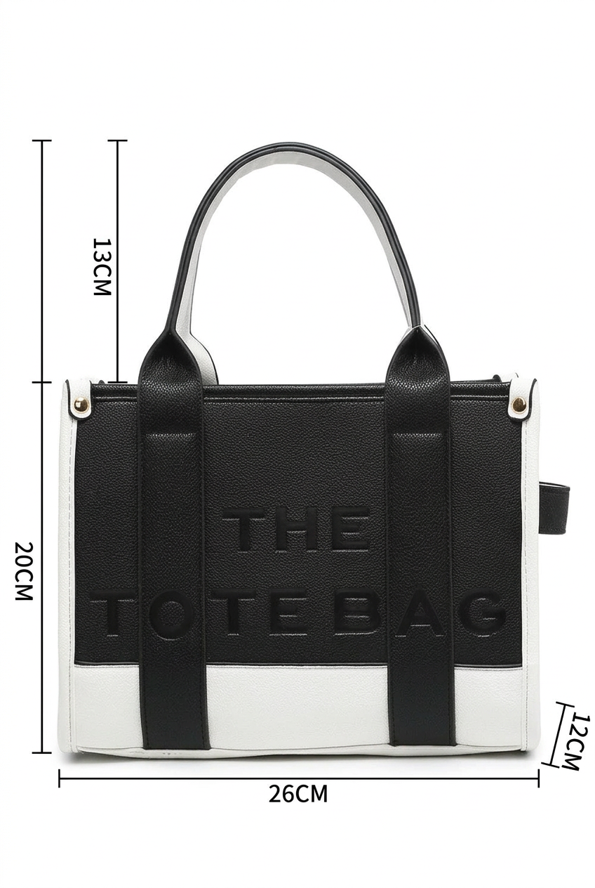 Black and white tote bag with embossed 'THE TOTE BAG' text, shown with dimension lines indicating 26cm width, 20cm height, 13cm handle height, and 12cm depth on a white background.