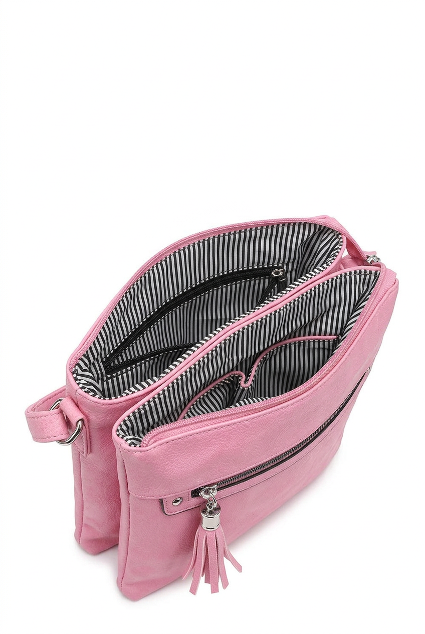 A pink crossbody bag shown open, displaying its striped black and white interior lining, zippered compartments, and a pink tassel zipper pull on a white background.