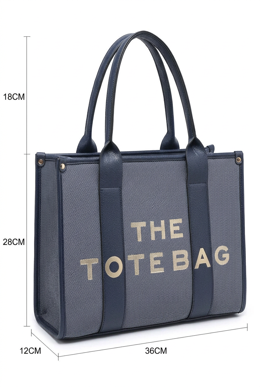A navy blue tote bag with a gray woven front panel and gold lettering that reads 'THE TOTE BAG'. The image includes dimension lines and labels showing the bag's height, width, and depth measurements.