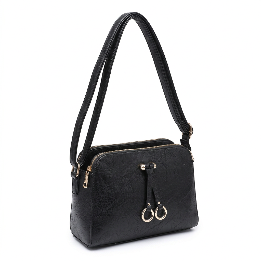 Black shoulder bag with a top zipper, gold-tone hardware, and two hanging ring charms, shown on a plain white background.