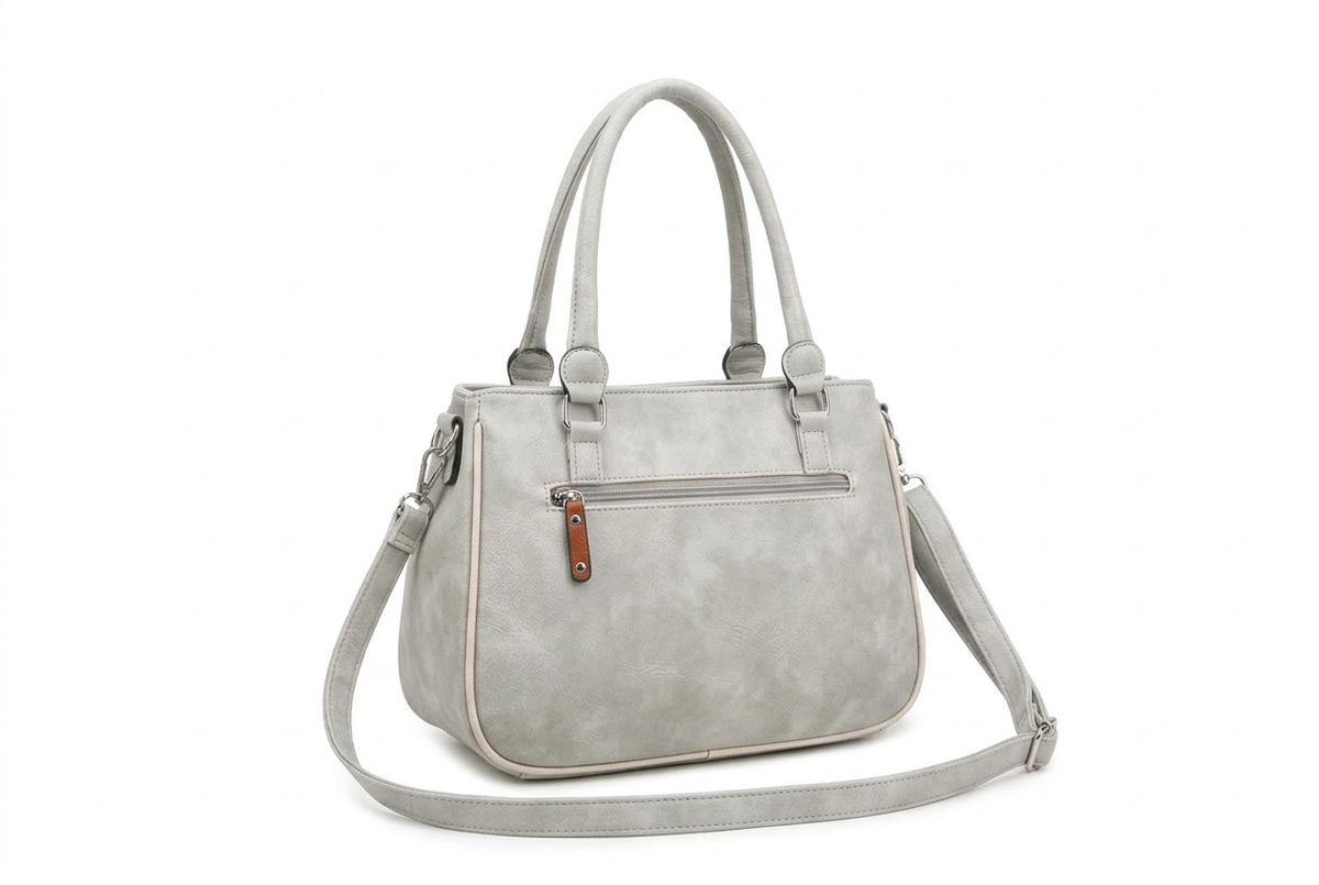 A light gray faux-leather handbag with dual top handles, a front zippered pocket, and a detachable shoulder strap, shown on a plain white background.