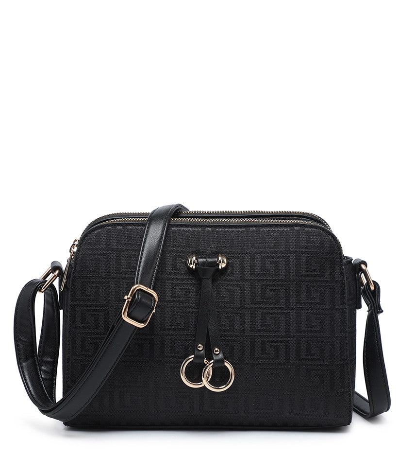 Black crossbody handbag with an embossed geometric monogram pattern, featuring a front zip closure, a detachable shoulder strap, and gold-tone hardware including a double-ring charm.