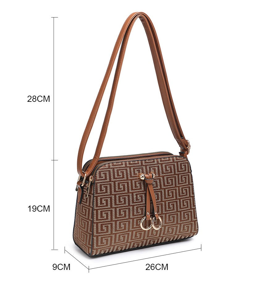 A brown patterned shoulder bag with a geometric Greek key design, shown with dimension lines indicating measurements of 28cm height, 26cm width, 9cm depth, and 19cm strap length.