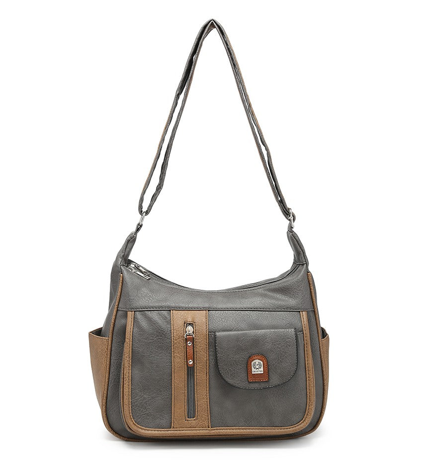 A gray and brown faux leather shoulder bag with a long strap, featuring a front pocket with a vertical zipper, side pockets, and a small leather brand patch on a white background.