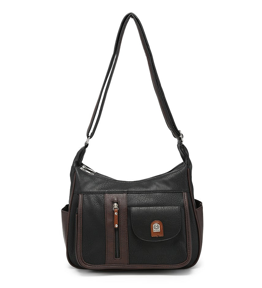 A black and dark brown faux leather shoulder bag with a front pocket, vertical zipper detail, side pockets, and a long shoulder strap, shown against a plain white background.