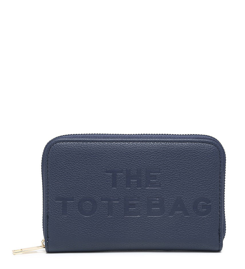 A navy blue pebbled zip-around wallet with 'THE TOTEBAG' embossed on the front, shown on a plain white background.