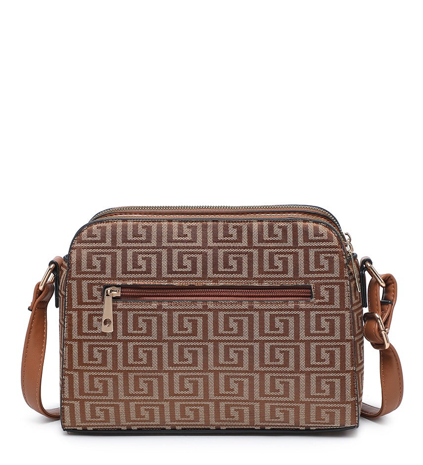 A brown and beige crossbody bag with a Greek key monogram pattern, featuring a front zippered pocket and a brown strap, shown against a plain white background.