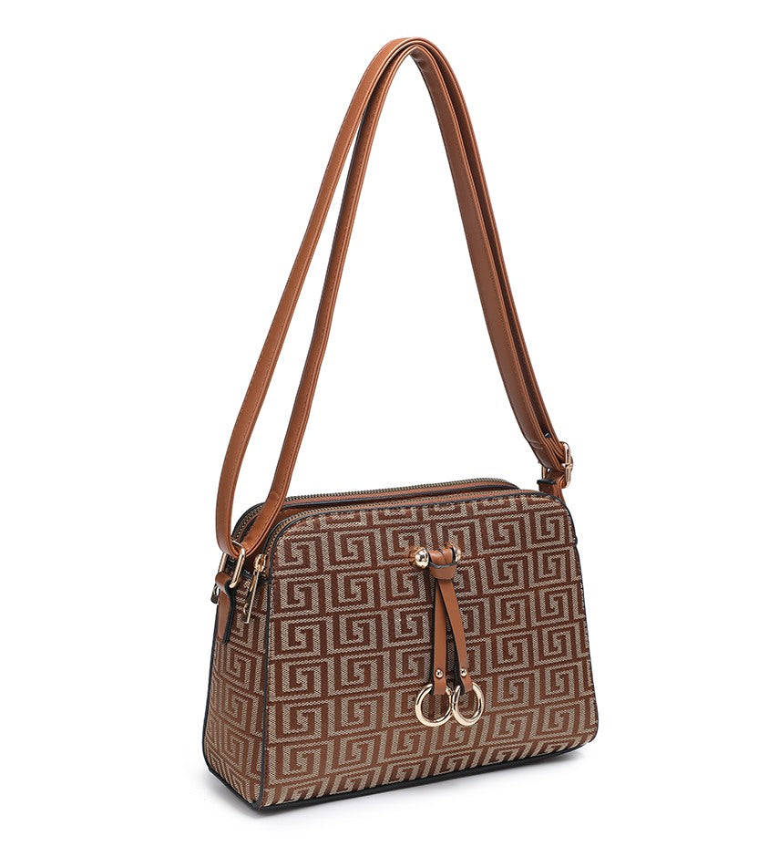 A brown and beige patterned shoulder bag with a tan strap and gold-tone hardware, shown on a plain white background.