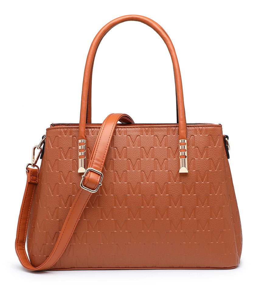 A structured brown handbag with an embossed monogram pattern, dual top handles, a detachable shoulder strap, and gold-tone hardware, shown on a plain white background.