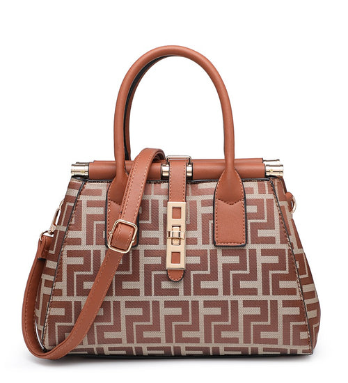 A structured handbag with a brown and beige geometric patterned body, tan handles and trim, and gold-tone hardware, shown on a plain white background.