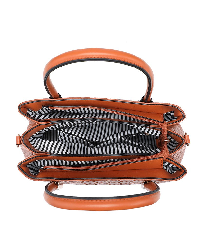 A top-down view of a structured brown handbag with a black and white striped interior lining, featuring a top handle and a curved bottom strap on a white background.